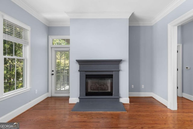 11 Perimeter Ctr E Unit 1404, Atlanta, GA 30346 - unfurnished living room featuring crown molding, wood finished floors, and a glass covered fireplace