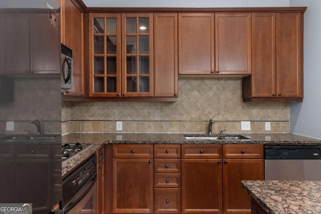 11 Perimeter Ctr E Unit 1404, Atlanta, GA 30346 - kitchen with stainless steel appliances, dark stone counters, glass insert cabinets, and backsplash