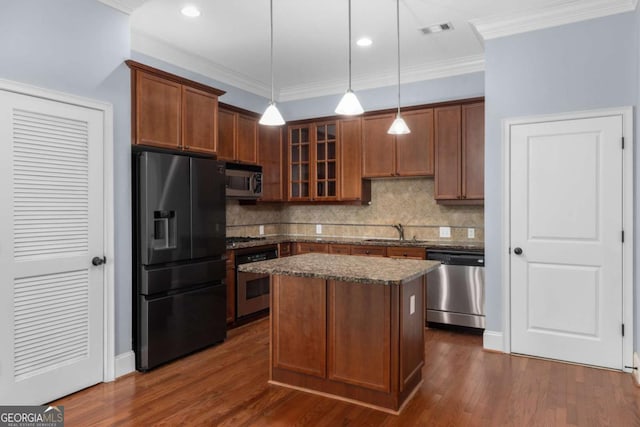 11 Perimeter Ctr E Unit 1404, Atlanta, GA 30346 - kitchen featuring appliances with stainless steel finishes, decorative backsplash, glass insert cabinets, a center island, and hanging light fixtures