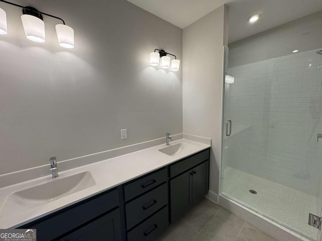 bathroom with tile patterned flooring, double vanity, a sink, and a stall shower