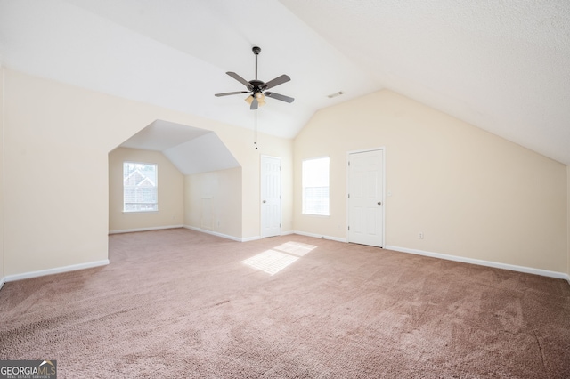 bonus room featuring carpet floors, visible vents, baseboards, ceiling fan, and vaulted ceiling