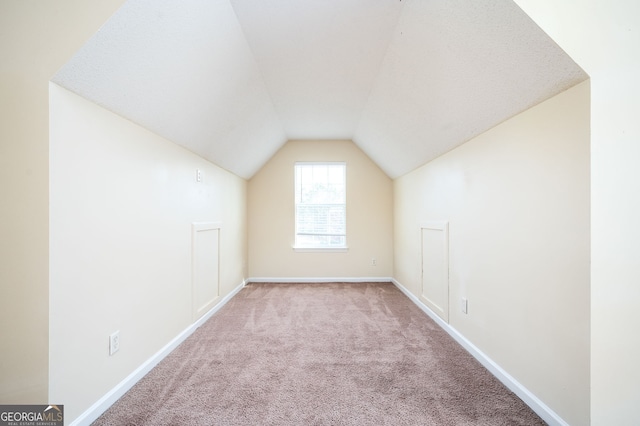 bonus room featuring vaulted ceiling, baseboards, and carpet floors