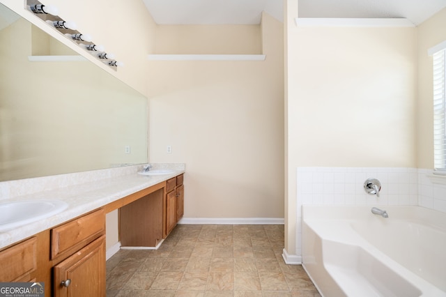 full bathroom with baseboards, a garden tub, double vanity, and a sink