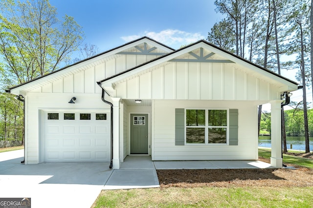 100 N Stewart Ln, Griffin, GA 30224 - modern inspired farmhouse featuring board and batten siding, an attached garage, a water view, and concrete driveway