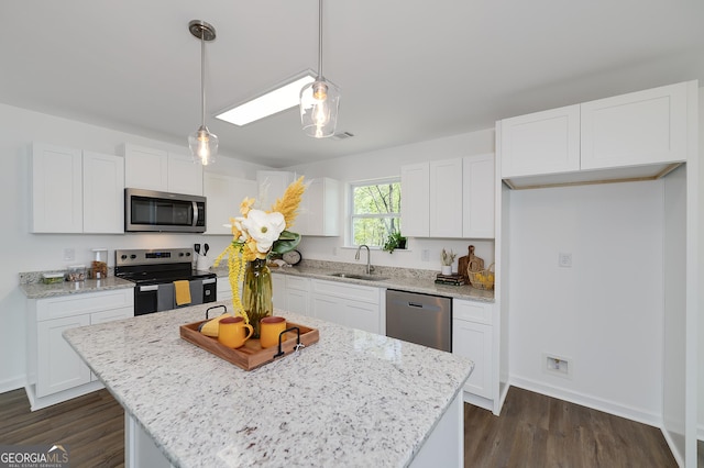 100 N Stewart Ln, Griffin, GA 30224 - kitchen featuring a sink, dark wood finished floors, white cabinets, and stainless steel appliances