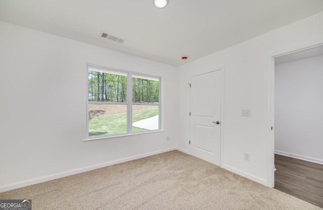 100 N Stewart Ln, Griffin, GA 30224 - unfurnished bedroom with carpet flooring, visible vents, and baseboards
