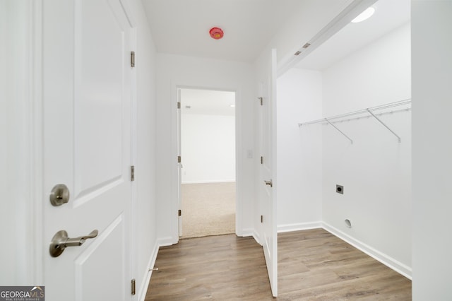 100 N Stewart Ln, Griffin, GA 30224 - clothes washing area featuring hookup for an electric dryer, baseboards, light wood finished floors, and laundry area