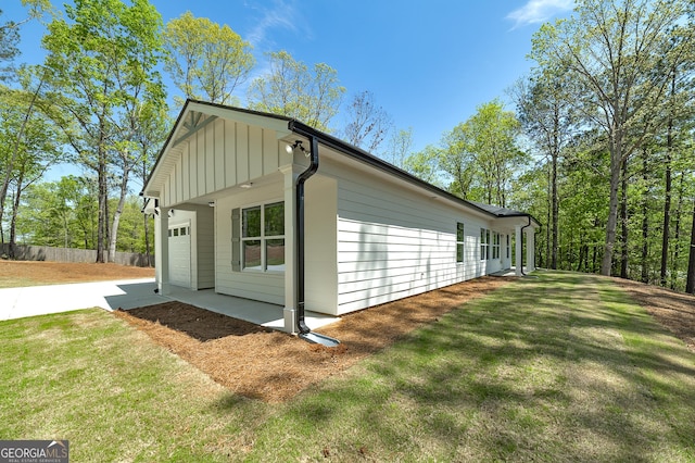 100 N Stewart Ln, Griffin, GA 30224 - view of side of property featuring an attached garage, driveway, fence, and a lawn