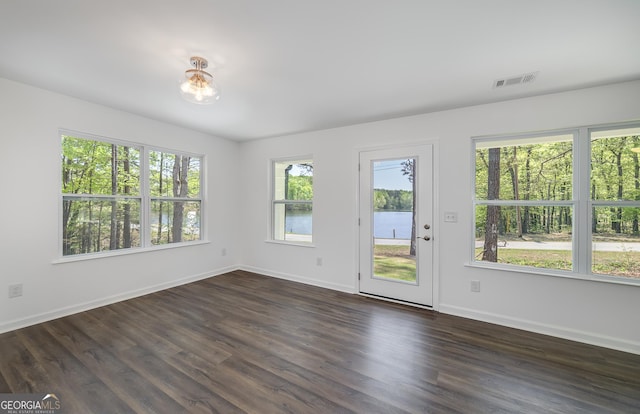 100 N Stewart Ln, Griffin, GA 30224 - unfurnished room featuring dark wood-type flooring, baseboards, and visible vents