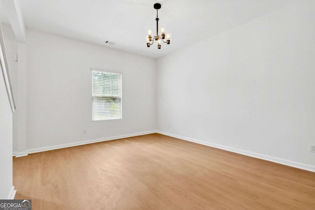 7431 Saint David St, Fairburn, GA 30213 - unfurnished room featuring a chandelier and wood finished floors