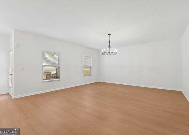 7431 Saint David St, Fairburn, GA 30213 - empty room featuring light wood finished floors and a chandelier