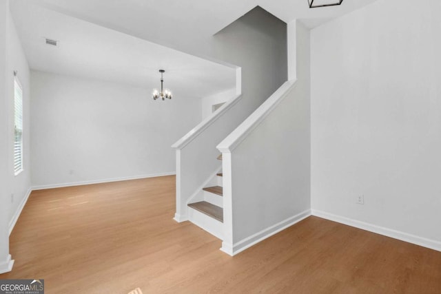 7431 Saint David St, Fairburn, GA 30213 - stairway with a chandelier and wood finished floors