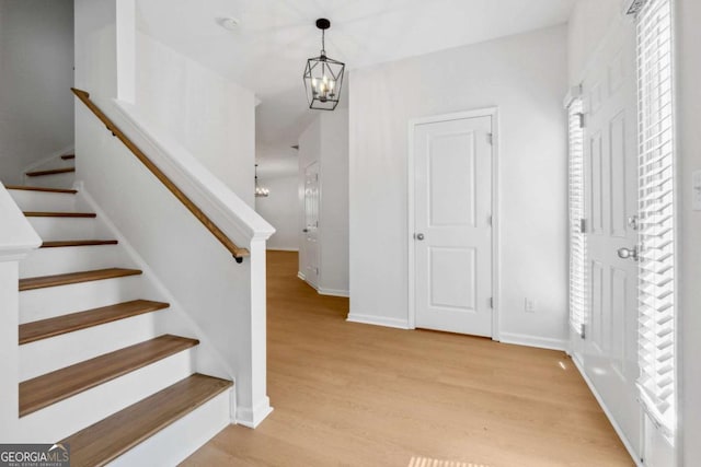7431 Saint David St, Fairburn, GA 30213 - staircase with a chandelier and wood finished floors