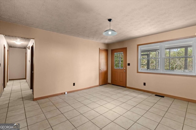 5026 Daniel Mill Rd, Winston, GA 30187 - unfurnished room with a textured ceiling, plenty of natural light, and light tile patterned floors