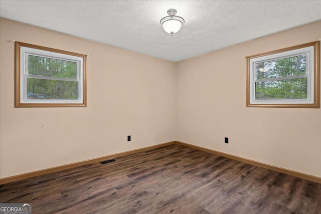5026 Daniel Mill Rd, Winston, GA 30187 - spare room with dark wood finished floors and a textured ceiling
