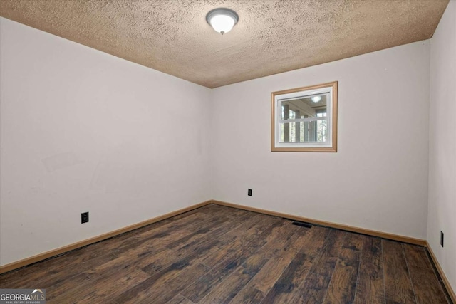 5026 Daniel Mill Rd, Winston, GA 30187 - unfurnished room with dark wood-style flooring and a textured ceiling