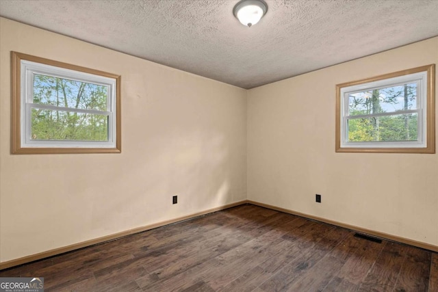 5026 Daniel Mill Rd, Winston, GA 30187 - empty room featuring dark wood finished floors, healthy amount of natural light, and a textured ceiling