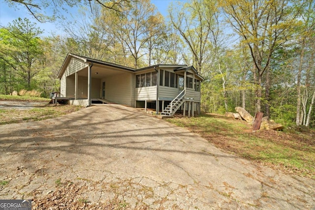 5026 Daniel Mill Rd, Winston, GA 30187 - view of front of home with a sunroom, asphalt driveway, and a carport