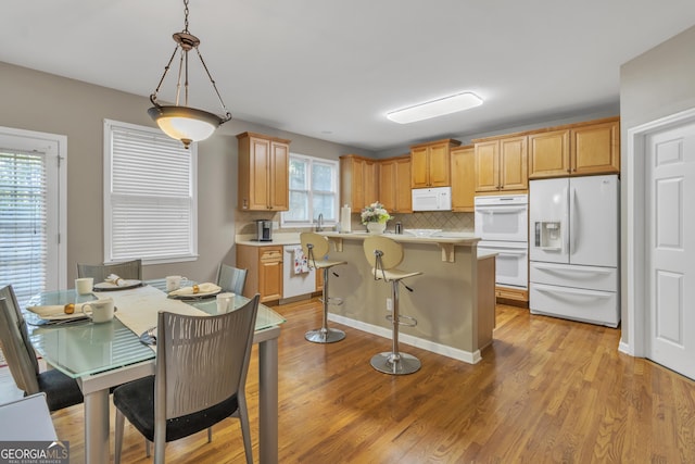 1812 Mountain Lake Dr NW, Kennesaw, GA 30152 - kitchen featuring white appliances, light countertops, decorative backsplash, and light wood-type flooring