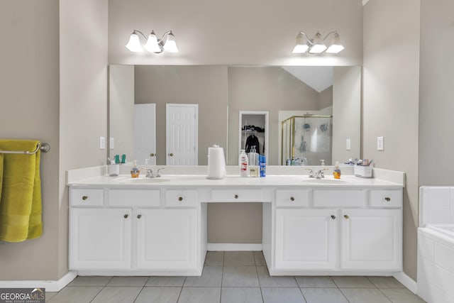 1812 Mountain Lake Dr NW, Kennesaw, GA 30152 - bathroom with a shower stall, double vanity, tile patterned floors, a walk in closet, and vaulted ceiling