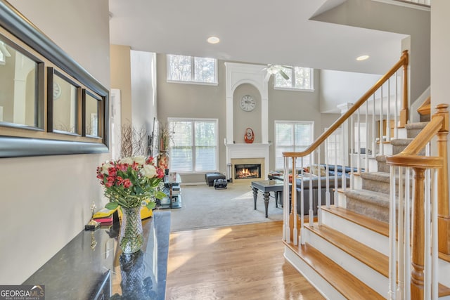 1812 Mountain Lake Dr NW, Kennesaw, GA 30152 - foyer entrance featuring ceiling fan, a warm lit fireplace, stairway, recessed lighting, and wood finished floors