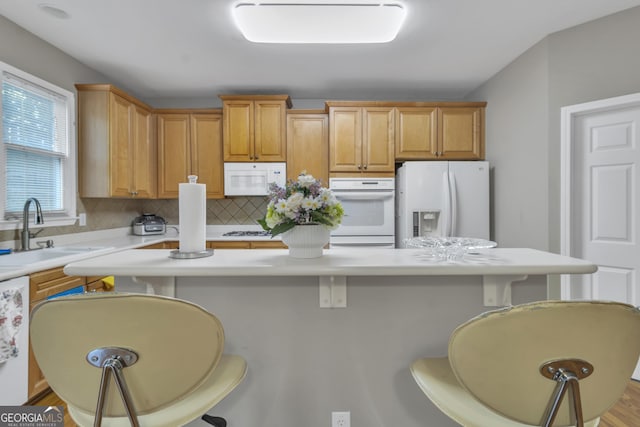 1812 Mountain Lake Dr NW, Kennesaw, GA 30152 - kitchen with white appliances, light countertops, a kitchen breakfast bar, backsplash, and a center island