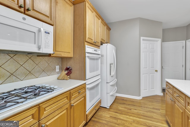 1812 Mountain Lake Dr NW, Kennesaw, GA 30152 - kitchen featuring white appliances, light wood-style floors, decorative backsplash, and light countertops