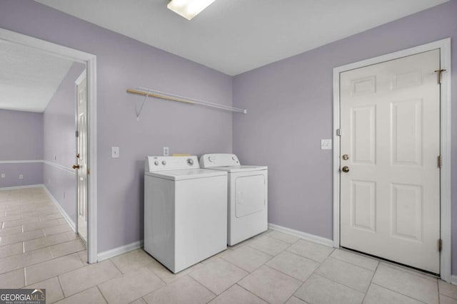 210 Preakness Dr, Hinesville, GA 31313 - laundry area with light tile patterned flooring, laundry area, washing machine and clothes dryer, and baseboards