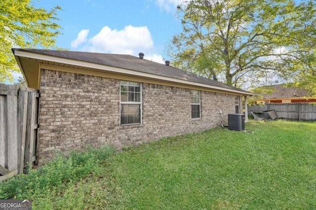 210 Preakness Dr, Hinesville, GA 31313 - back of house featuring central air condition unit, fence, and a lawn