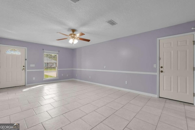 210 Preakness Dr, Hinesville, GA 31313 - entryway featuring baseboards, light tile patterned floors, a textured ceiling, visible vents, and ceiling fan