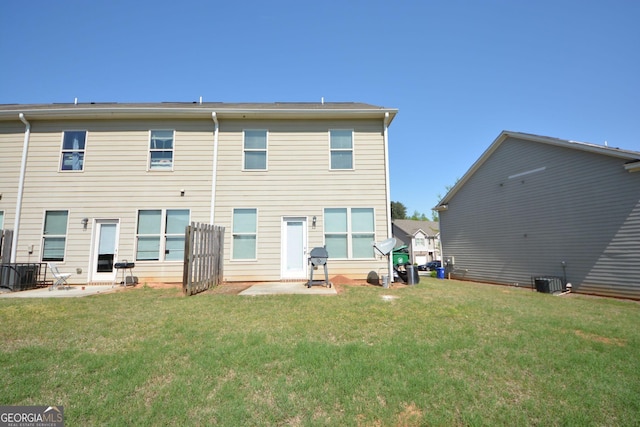 rear view of house featuring a patio, a lawn, and central air condition unit
