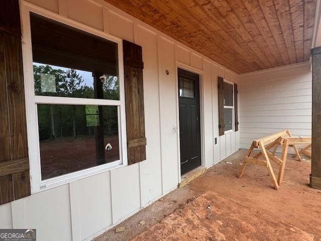 entrance to property featuring a porch and board and batten siding