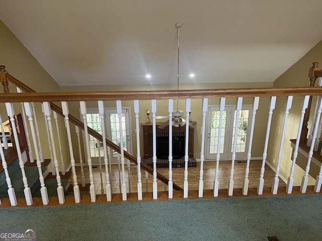 staircase with recessed lighting and a brick fireplace