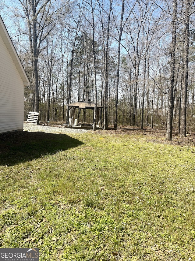 view of yard with a carport and a gazebo