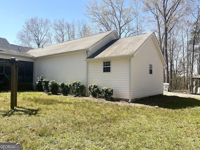 view of home's exterior featuring a yard and roof with shingles