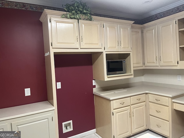 kitchen featuring ornamental molding, stainless steel microwave, light countertops, and open shelves