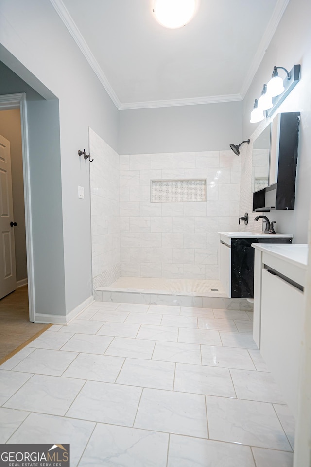 full bathroom featuring a tile shower, crown molding, and vanity