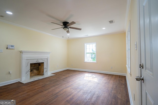 unfurnished living room featuring ornamental molding, dark wood finished floors, a ceiling fan, and visible vents