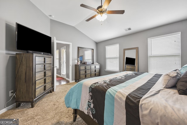 bedroom with baseboards, vaulted ceiling, and multiple windows