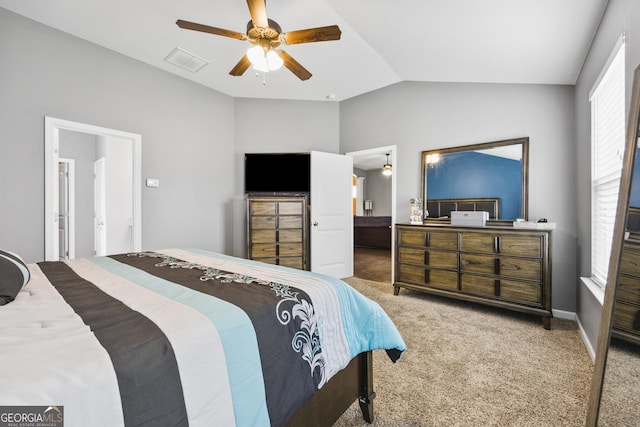 carpeted bedroom featuring a ceiling fan, visible vents, and lofted ceiling