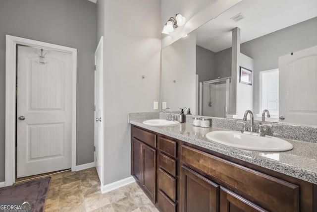 full bathroom featuring a sink, a stall shower, double vanity, and visible vents