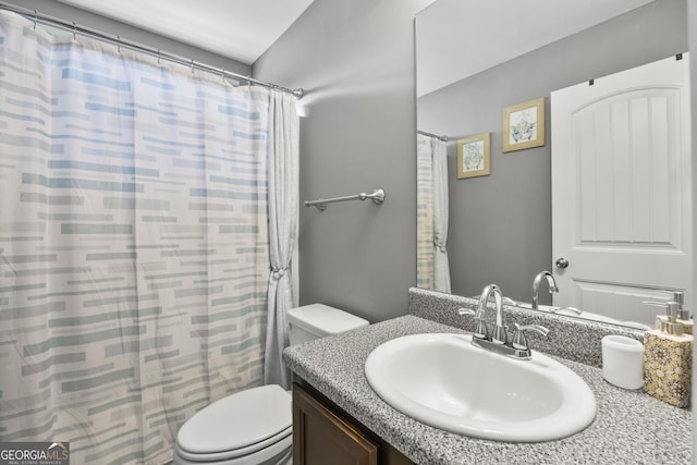 full bathroom with vanity, curtained shower, and toilet