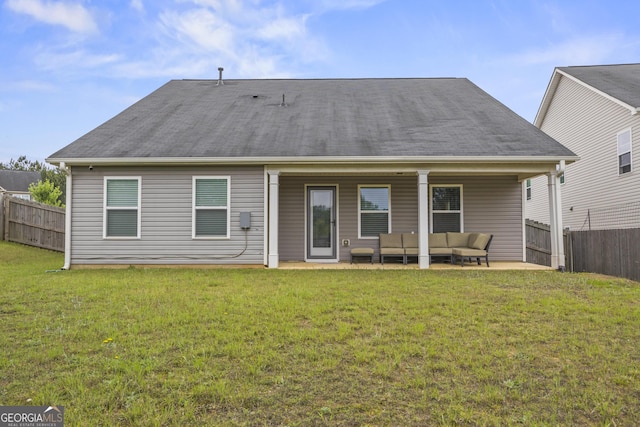 rear view of property with a yard, a patio, outdoor lounge area, and fence private yard