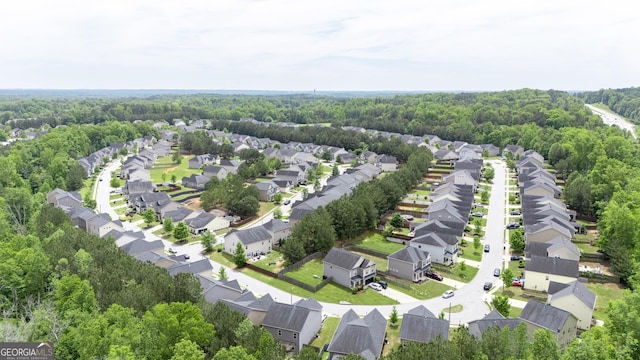 birds eye view of property featuring a wooded view and a residential view