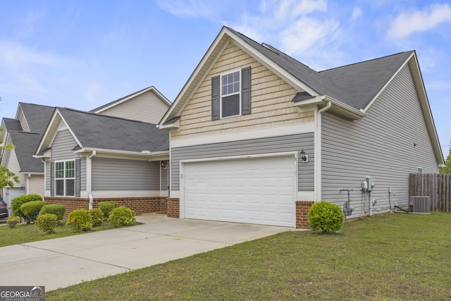 view of front of home featuring brick siding, driveway, a front yard, and a garage
