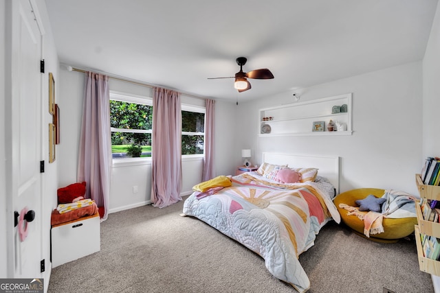 carpeted bedroom featuring baseboards and a ceiling fan