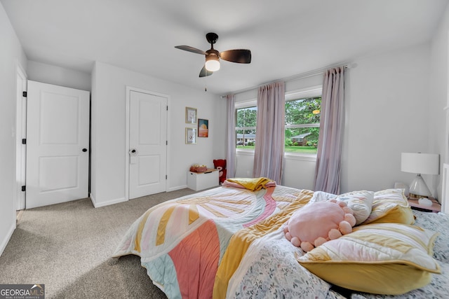 bedroom with ceiling fan, carpet floors, and baseboards