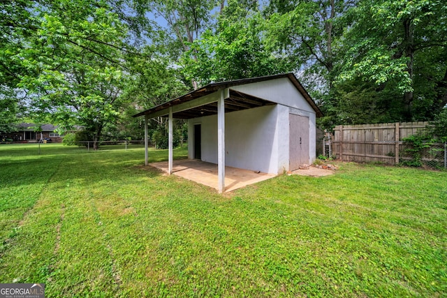 view of outbuilding featuring fence and an outbuilding