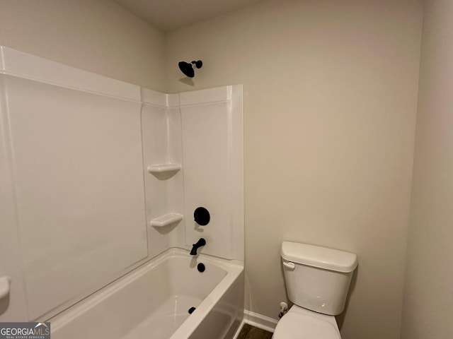 bathroom with baseboards and toilet