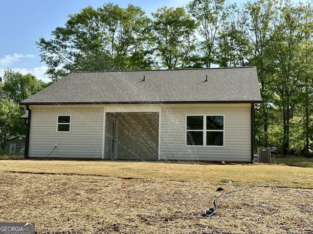 back of property featuring roof with shingles